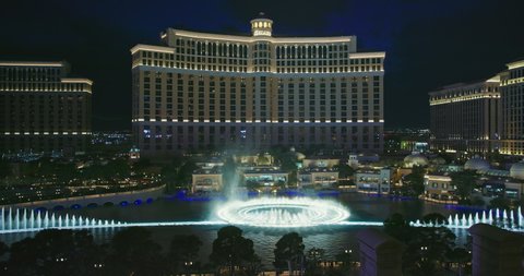 Las Vegas, March 2021. Night show of Bellagio fountains. Fantastic dancing fountains at world famous resort and casino hotel building on Strip. Night life with street entertainments and attractions 4k