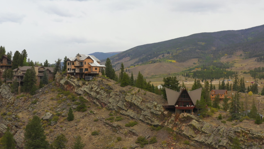 drone shot of mountain cabins on a hill in the rockies of colorado