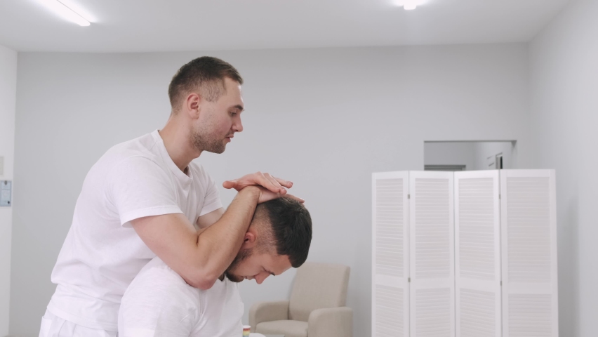 Physiotherapist in kinesio clinic working and massaging patient