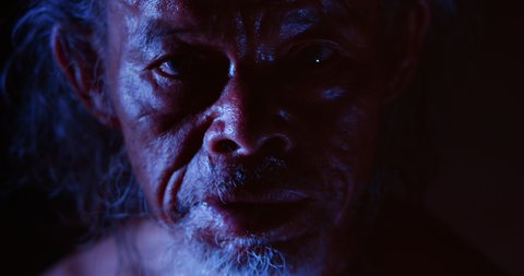 Slow motion night scene, face of Asian old man, white hair, white beard, white beard, rough skin, mysterious look. Used in the concept of occultism, sorcerers, mysticism, sorcery