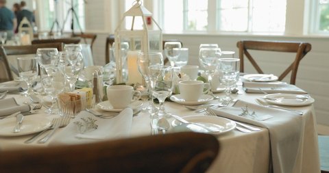 Elegant white wedding reception dinning table setup at a restaurant venue at the Strathmere Wedding venue and resort spa.