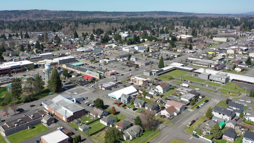 Cinematic aerial drone footage of downtown Marysville, by the I-5 freeway, a distant suburb, bedroom community North of Seattle on the shores of Puget Sound in Washington