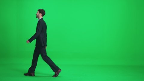 Passer-by man in a suit walks on a green background, a happy men walks down the street, template on a chromakey.