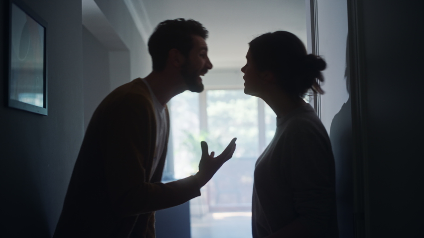 Young Couple Arguing and Fighting. Domestic Violence and Emotional abuse Scene, Stressed Woman and aggressive Man Screaming at Each other in the Dark Hallway of Apartment. Dramatic Scene | Shutterstock HD Video #1070800687