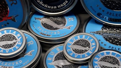 Moscow, Russia-April 12, 2021: caviar of different varieties in tin cans on the counter in a fish store. common name of sturgeon ROE. Traditional black caviar is given by sturgeon, Beluga, sturgeon