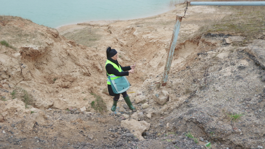 Woman environmental inspector taking photos on tablet