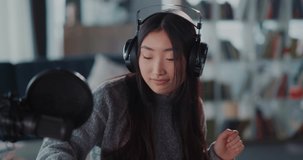 Portrait of lovely chinese young singer artist recording music podcast playing on webcam staying home broadcasting. Talented people.