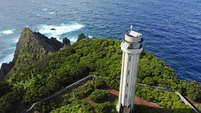 Lighthouse of Ponta dos Rosais. Sao Jorge, Azores, Portugal. Panoramic view of an abandoned beacon on a cliff. Aerial footage a beautiful volcanic island with the ocean behind. High quality 4k footage