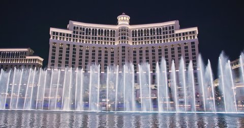 Las Vegas, March 2021. Amazing water show at night city. Bellagio fountains dancing illuminated at night. Capital of adult night shows, casino and entertainment. 4K footage world famous Las Vegas