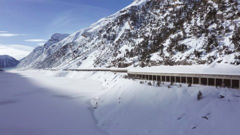 Drone clips of Lago del Gallo, close to Livigno, early morning, winter