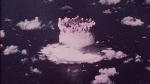 1945 Alamogordo, New Mexico. Montage of Nuclear Explosions for testing during the Manhattan Project. Close-up of finger pushing button. 4K Overscan of Vintage Archival 16mm Film Print