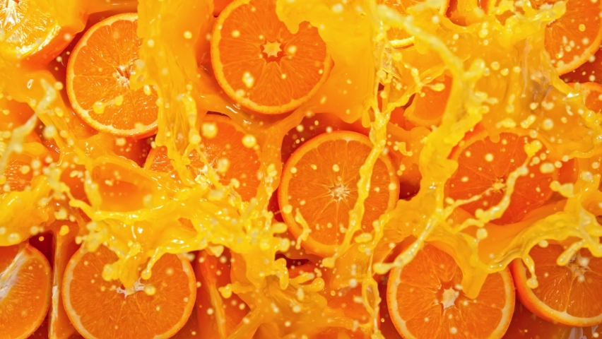 Super Slow Motion Shot of Fresh Orange Juice Splashing through Orange Slices at 1000fps. Royalty-Free Stock Footage #1070870260