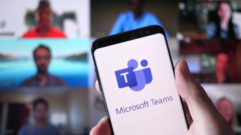 Microsoft Teams logo on a smartphone and on the background the website on a computer monitor. MONTREAL CANADA APRIL 2021