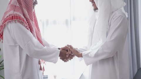portrait of business muslim partner shaking hand in the meeting