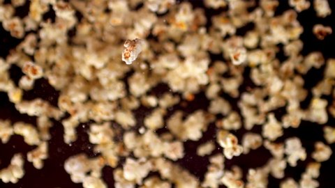 Super slow motion popcorn rises up. On a black background.Filmed on a high-speed camera at 1000 fps. High quality FullHD footage