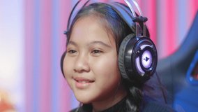 Kid Girl Feels Funny When Playing A Video Game, Child In A Headset Focused On A Computer Game
