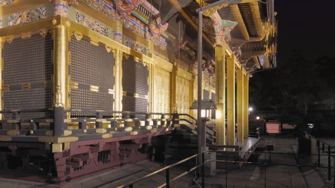 tokyo, japan - april 05 2021: Pan video of the luxurious gold foil Ueno Tosho-gu shrine dedicated to the first Shogun of Edo era Tokugawa Ieyasu and classed as Important cultural property at night.