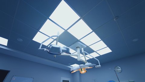 Medical lamps lighting in the operating room. Ceiling with many lamps in clinic. Surgery department in hospital.