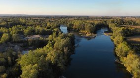 Aerial cinematic river view. Drone video - Velika Morava in Serbia. Sunset on the river.