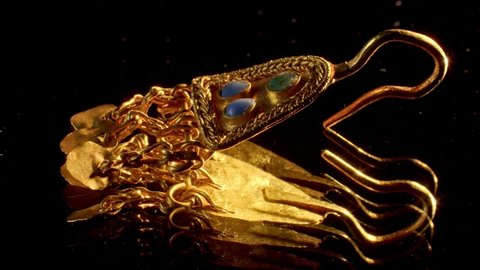 gold earring of a Scythian priestess 2000 years old, an old earring, spinning, found during excavations
