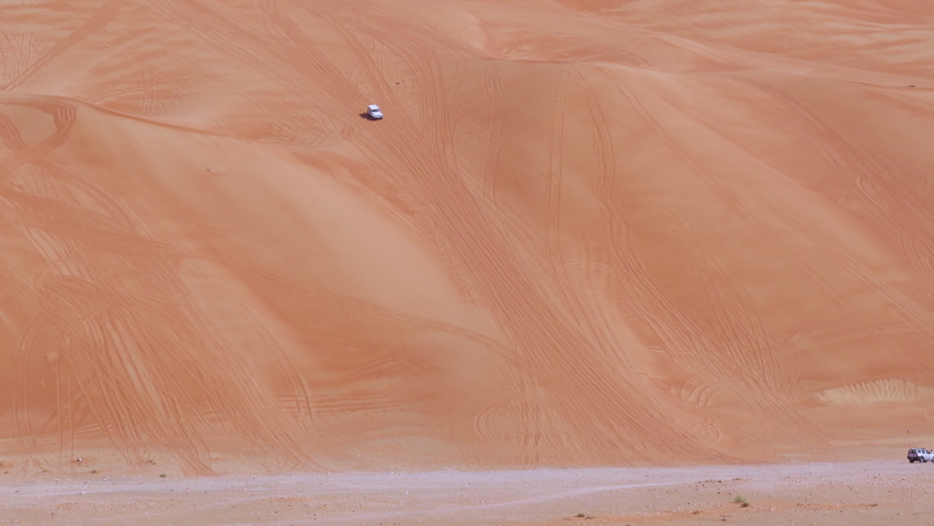 4WD (four wheel drive) Vehicle Goes Off-road In Huge Desert Sand Dunes In Sharjah, United Arab Emirates - wide shot