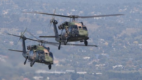 CANBERRA, AUSTRALIA - MARCH, 31, 2021: slow motion tracking clip of two black hawk helicopters approaching during the raaf centenary flypast