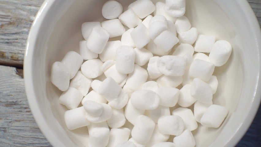 sweet food.a small marshmallow falls into a cup.top view.close-up.