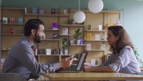 Indian male hr specialist manager, employer, boss talking to female latin candidate at job interview, consulting client at office meeting. Hiring and employment, insurance, recruitment concept. - Powered by Shutterstock - Get 15% off with code: PIKWIZARD15