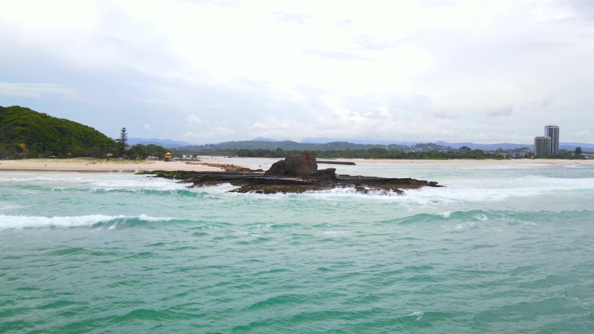 Ocean Waves Crashing On Rock Formations At Currumbin Beach - People Standing At Rocky Coast Of Beach At Currumbin, QLD, Australia. - aerial approach