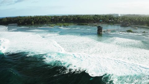 Cloud 9 - popular surf spot on Siargao Island, Philippines. Long waves and observation tower. Aerial flight back, 4k