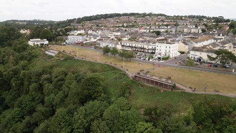Aerial Drone Video Of high lying Torquay Town with greened cliffs and beautiful rocky ocean shore below.