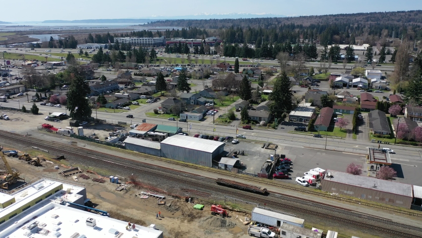 Cinematic aerial drone panning footage of downtown Marysville, by the I-5 freeway, a distant suburb, bedroom community North of Seattle on the shores of Puget Sound in Washington