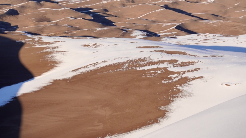Tilting gimbal shot of sand dunes and mountains