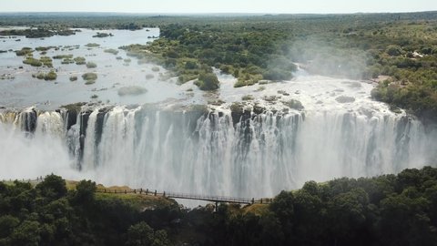 The Victoria Falls at the Border of Zimbabwe and Zambia in Africa. The Great Victoria Falls One of the Most Beautiful Wonders of the World. Aerial Shot From Above. Camera Moves Forward