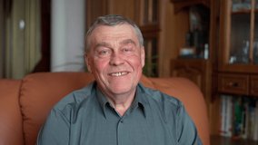 Happy elderly senior gray-haired 60s man portrait smiling face healthy teeth sit on sofa. relaxed old retired single grandfather posing alone at home look at camera and smiling indoors, close up adult - Powered by Shutterstock - Get 15% off with code: PIKWIZARD15