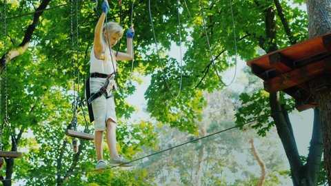 Girl overcomes fear, walks on a rope high above the ground