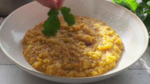 Vegan lentil soup dal with cilantro. Indian cuisine concept.