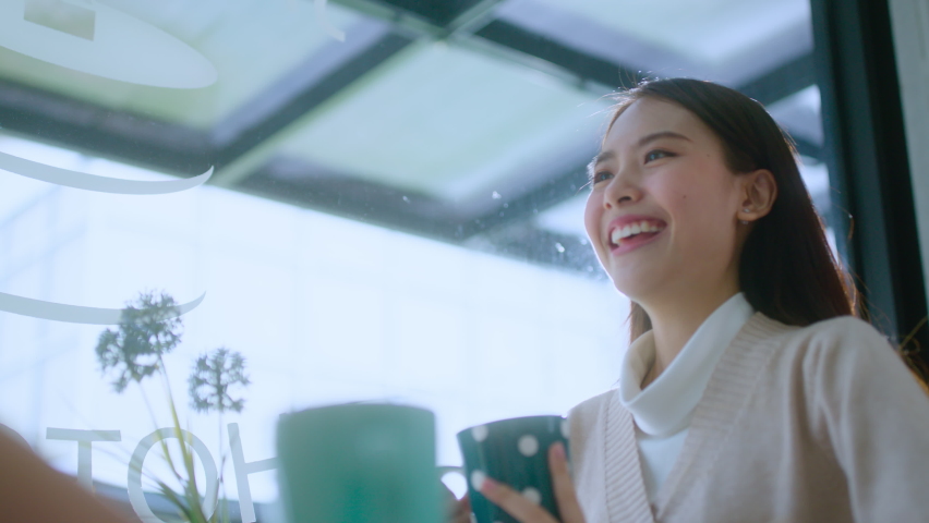 Attractive asian female talking good positive conversation to friends with smiling laugh and happiness moment at counter near window at cafe with daylight from garden positive attitude relationship | Shutterstock HD Video #1070955184