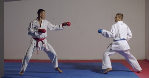 Karate men fighting each other in the gym