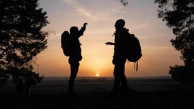 teamwork. business a journey concept win. happy family team tourists man and woman sunset silhouette help shake teamwork hands victory success business . slow motion video. tourism husband top group