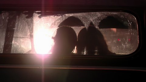 Buenos Aires, Argentina - March 2021: Silhouette of Two Teenagers in Love inside a Parked Car at Night.  