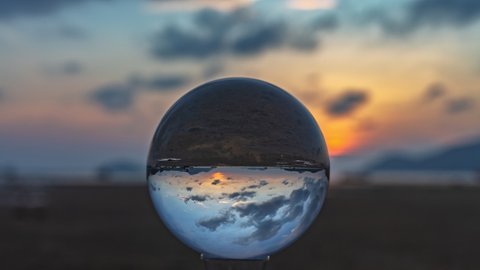 The view in a crystal ball looks like no other. 4K Videos for beautiful and unusual travel ideas.
time lapse clouds moving in beautiful sky in sunrise above the sea. 