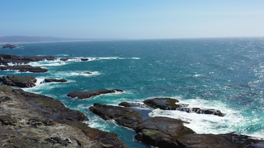 The Pacific Ocean batters the rugged shore of Northern California in Mendocino on a beautiful day. This region is known for its scenic mountains, forests, and coastline.