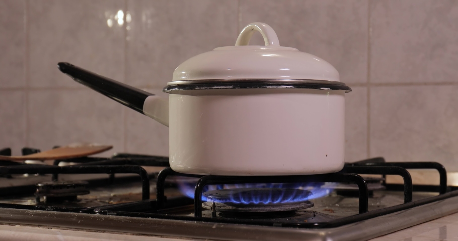 Pot boiling over with oatmeal bursting spilling out on gas stove Royalty-Free Stock Footage #1070975221