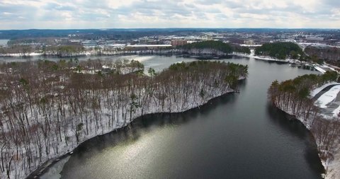 Aerial view of Lake Cochituate in winter with snow in Cochituate State Park in town of Natick, Massachusetts MA, USA. 