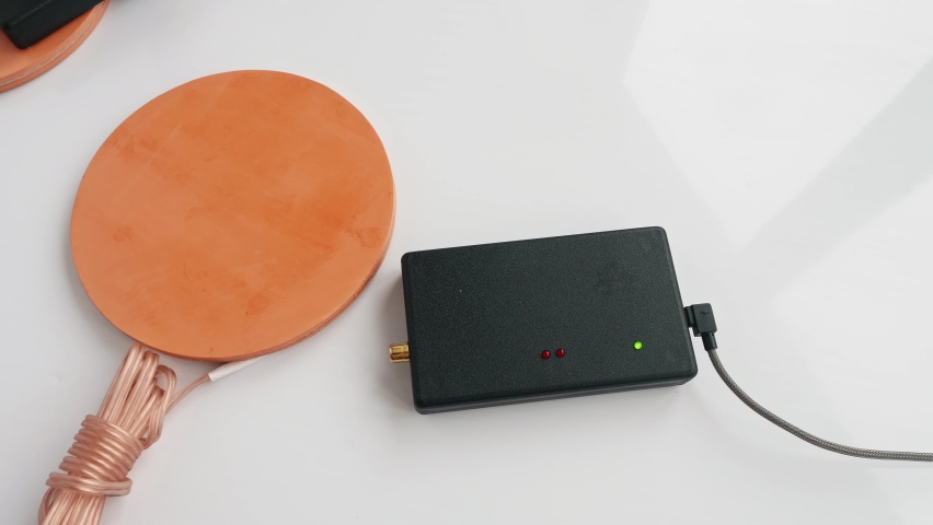 Up view of man hands fixing assembling parts of Mishin coil to start treatment procedure. Traditional medecine.