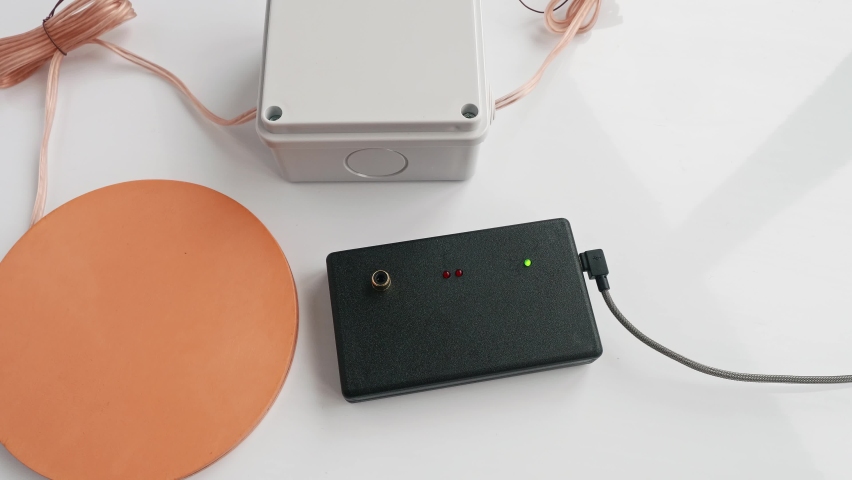 Up view of man hands fixing assembling parts of Mishin coil to start treatment procedure. Traditional medecine.