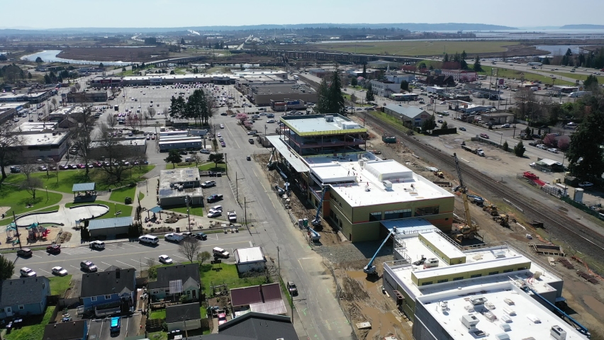 Cinematic aerial drone clip of downtown Marysville, by the I-5 freeway, a distant suburb, bedroom community North of Seattle on the shores of Puget Sound in Washington
