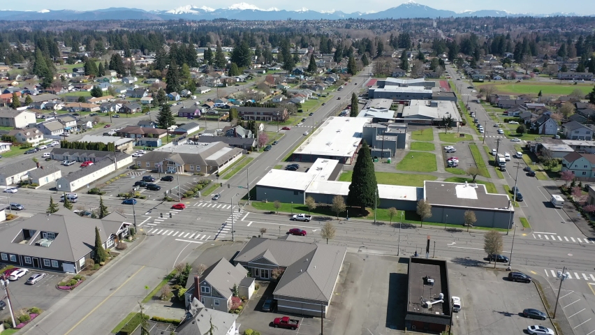 Cinematic aerial drone panning clip of downtown Marysville, by the I-5 freeway, a distant suburb, bedroom community North of Seattle on the shores of Puget Sound in Washington