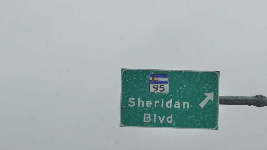 Sheridan Boulevard Exit Sign From Interstate 25 Highway, Driving on Snowy Winter Weather in Colorado USA
